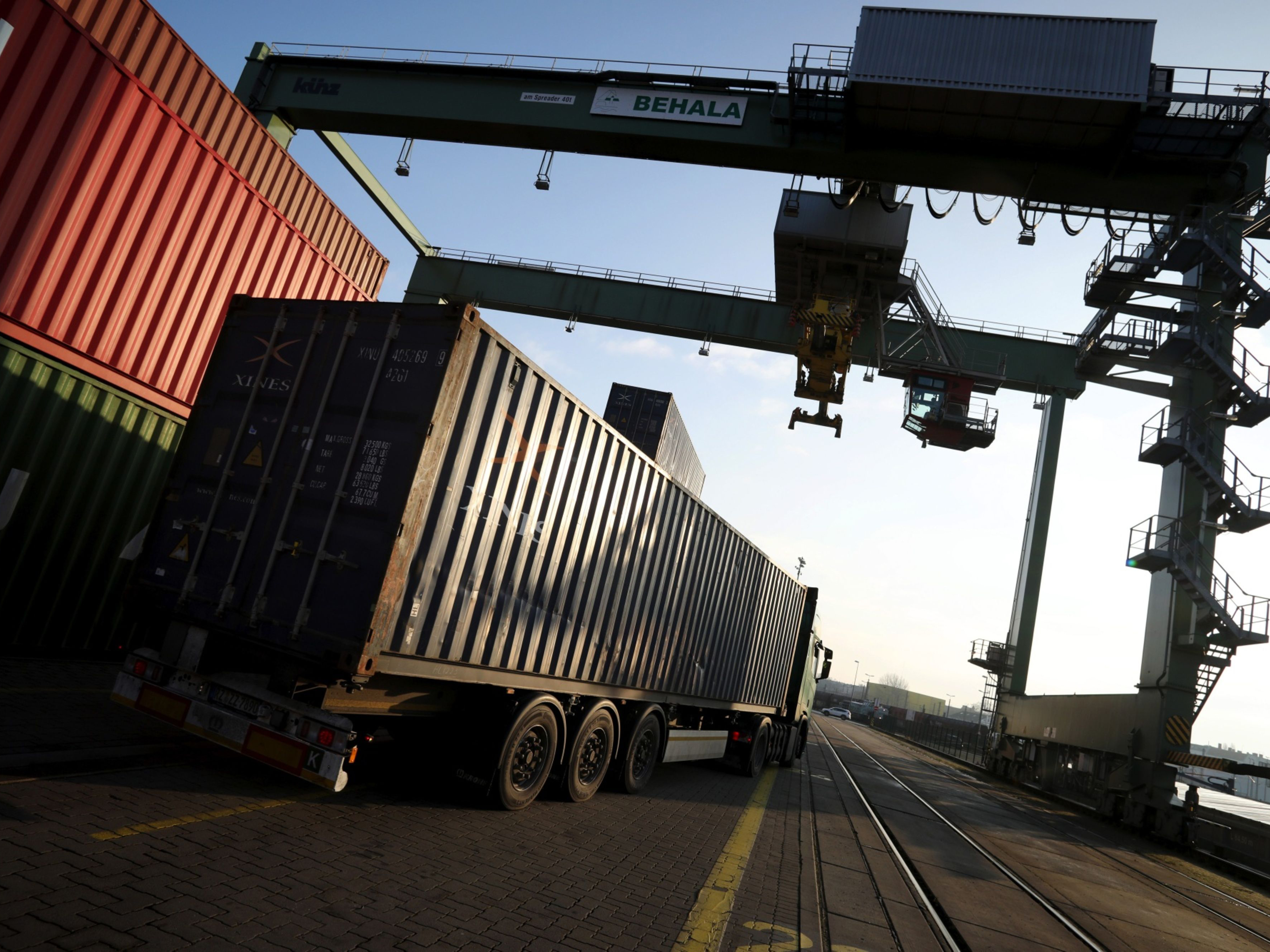 A haulage truck transports a shipping container. 