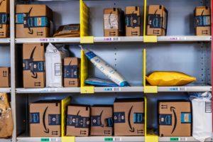 A collection of Amazon packages on three shelves