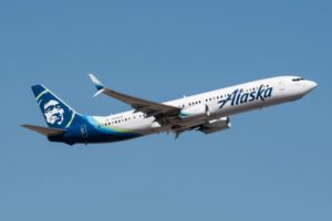 A BOEING 737-900ER FLIES ACROSS THE SKY