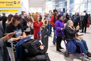 A CROWD OF PASSENGERS AT HEATHROW AIRPORT