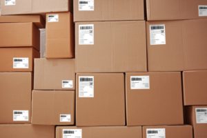 A TOWERING PILE OF BOXES IN A WAREHOUSE.jpg