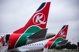 PLANE TAILS SPORTING RED, GREEN AND WHITE INSIGNIAS, FORM A ROW