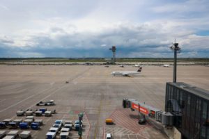 A PLAN BEARING THE LUFTHANSA LOGO SITS ON THE TARMAC OF AN AIRPORT