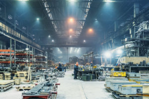 THE INTERIOR OF A METALWORKING FACTORY WORKSHOP HANGAR.