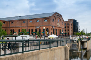 EXTERIOR OF THE REI CO-OP HISTORICAL BUILDING. A STARBUCKS LOGO CAN BE SEEN ON THE FRONT AND SIDE OF THE BRICK BUILDING.