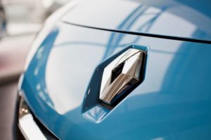 A BRIGHT BLUE CAR HOOD BEARS THE RENAULT INSIGNIA