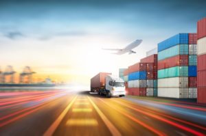 A TRUCK LEAVES A PORT DOCK LOADED WITH A CONTAINER