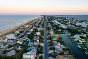 AN AERIAL VIEW OF VIRGINIA BEACH, VIRGINIA CAN BE SEEN DURING A SUNSET